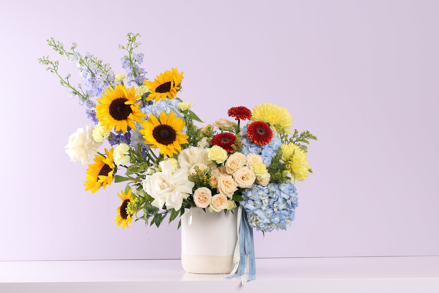 Soleil Vif Arrangement - sunflowers, hydrangeas and roses in white vase